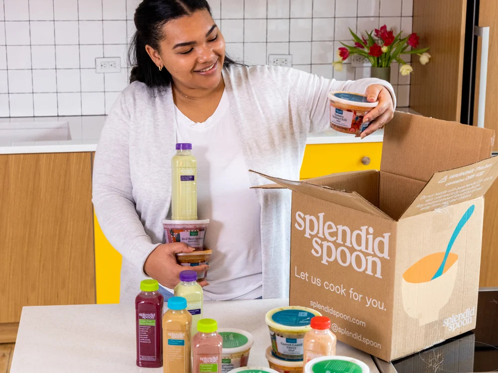 Woman opening box of splendid spoon.